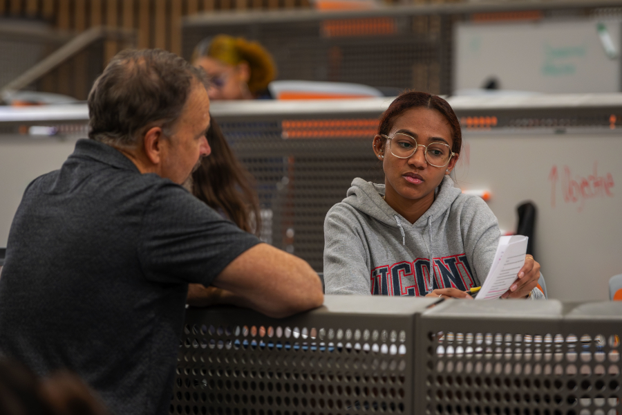 Professor Bradley Wright talks with a student during class in the Science 1 building on Oct. 10, 2023.